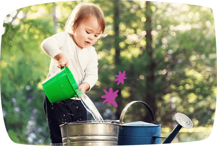 little girl pourin water into a bucket